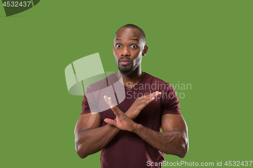 Image of The young man whispering a secret behind her hand