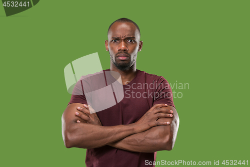 Image of The serious businessman standing and looking at camera