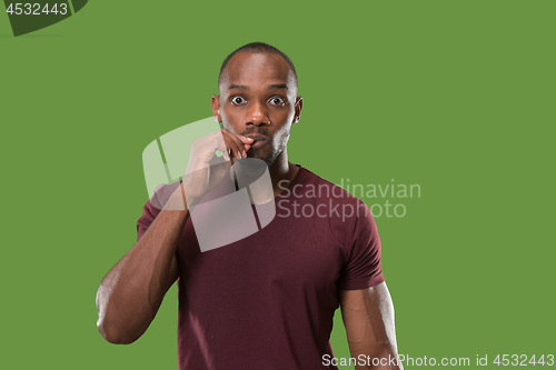 Image of The young man whispering a secret behind her hand