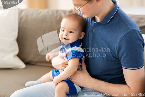 Image of happy father with baby son at home