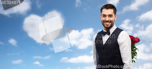 Image of happy man with red roses behind his back