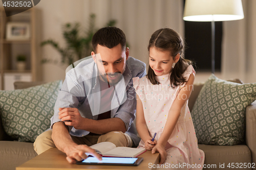 Image of father and daughter doing homework together