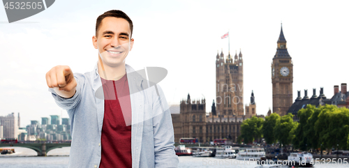 Image of man pointing finger to you over london background