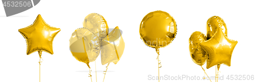 Image of many metallic gold helium balloons on white