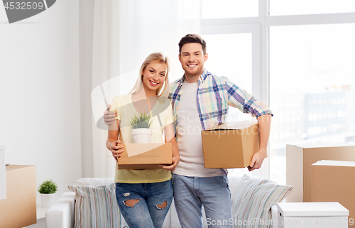 Image of happy couple with boxes moving to new home