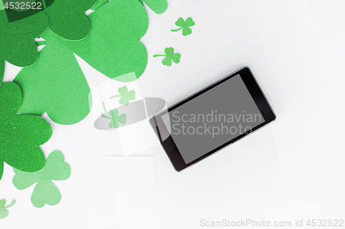 Image of tablet pc and st patricks day decorations on white