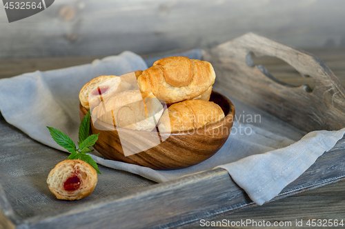 Image of Croissants on a wooden tray. The concept of a wholesome breakfast.
