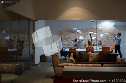 Image of Group of young business people throwing documents