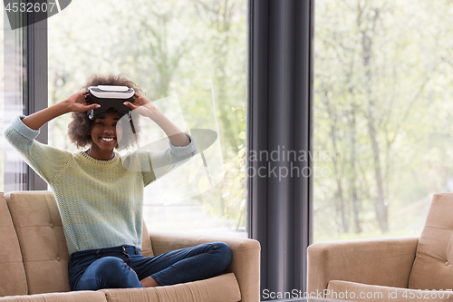 Image of black woman using VR headset glasses of virtual reality