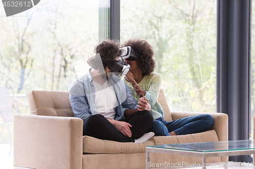 Image of Multiethnic Couple using virtual reality headset