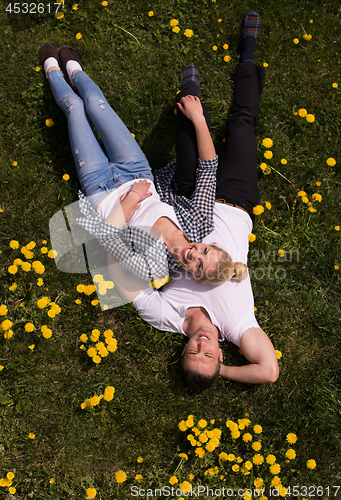 Image of man and woman lying on the grass