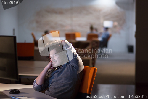 Image of businessman relaxing at the desk