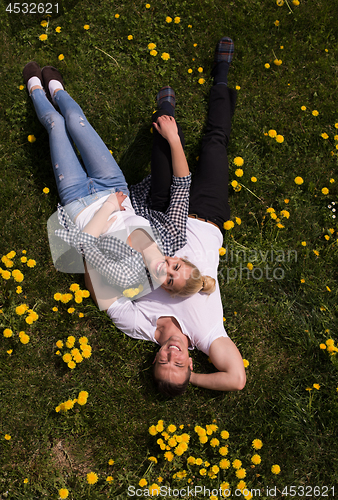 Image of man and woman lying on the grass
