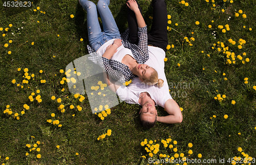 Image of man and woman lying on the grass