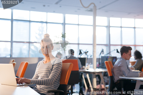 Image of businesswoman using a laptop in startup office