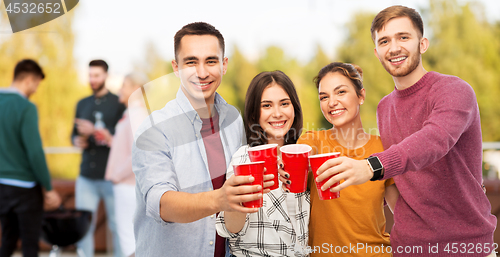 Image of group of friends toasting drinks at rooftop party