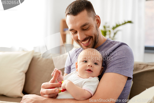 Image of happy father with little baby daughter at home