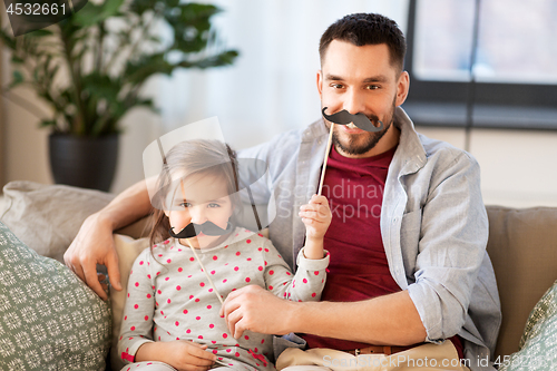 Image of father and daughter with mustaches having fun