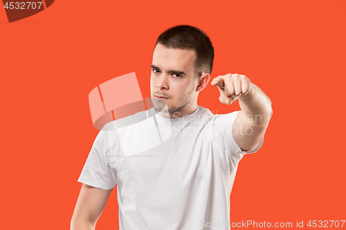 Image of The overbearing businessman point you and want you, half length closeup portrait on orange background.