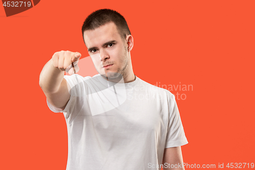 Image of The overbearing businessman point you and want you, half length closeup portrait on orange background.
