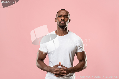 Image of The serious businessman standing and looking at camera .