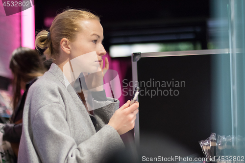 Image of Women buying and testing cosmetics in a beauty store