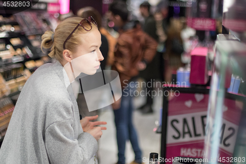 Image of Women buying and testing cosmetics in a beauty store