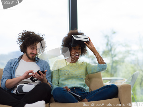 Image of Multiethnic Couple using virtual reality headset