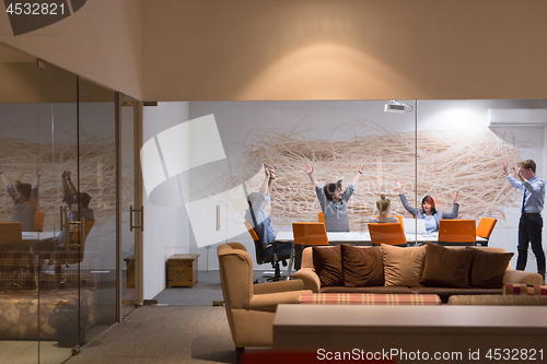 Image of Group of young business people throwing documents