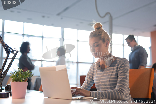 Image of businesswoman using a laptop in startup office