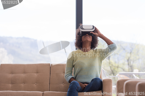 Image of black woman using VR headset glasses of virtual reality