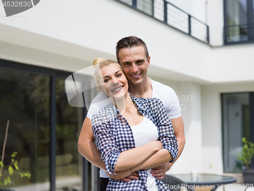 Image of couple hugging in front of  new luxury home