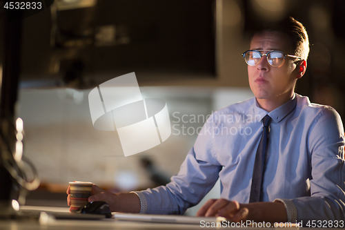 Image of Tired businessman working late