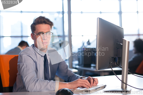 Image of businessman working using a computer in startup office