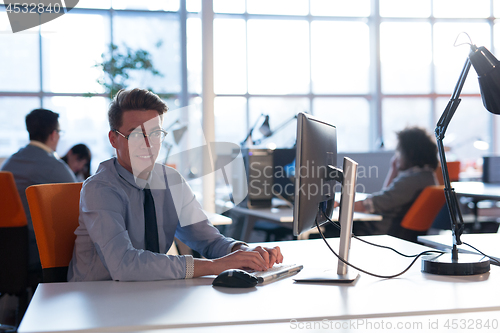Image of businessman working using a computer in startup office