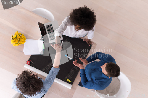 Image of top view of Multiethnic startup business team on meeting