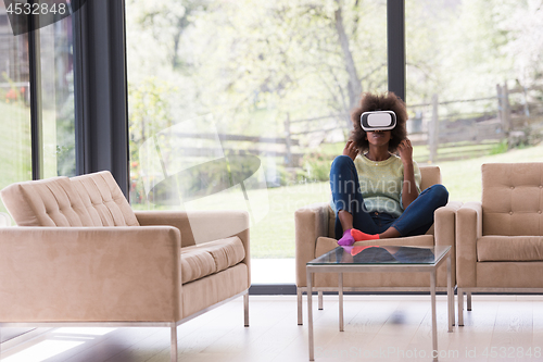 Image of black woman using VR headset glasses of virtual reality