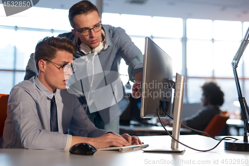 Image of Two Business People Working With computer in office