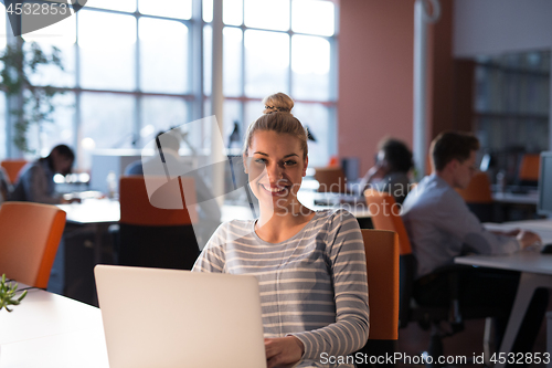 Image of businesswoman using a laptop in startup office