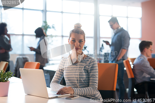 Image of businesswoman using a laptop in startup office