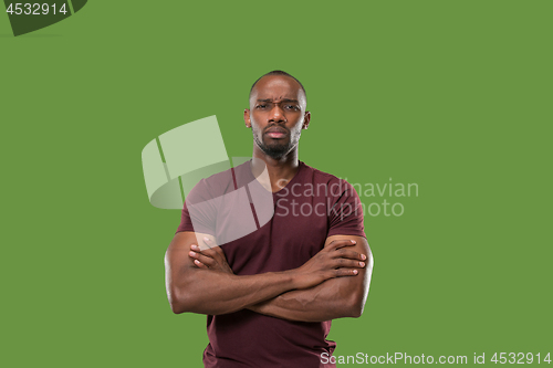 Image of The serious businessman standing and looking at camera .