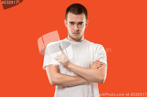 Image of Young serious thoughtful businessman. Doubt concept.