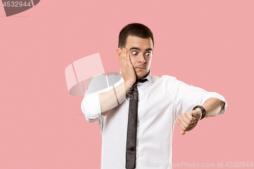 Image of Handsome businessman checking his wrist-watch Isolated on pink background