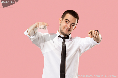 Image of The overbearing businessman point you and want you, half length closeup portrait on pink background.