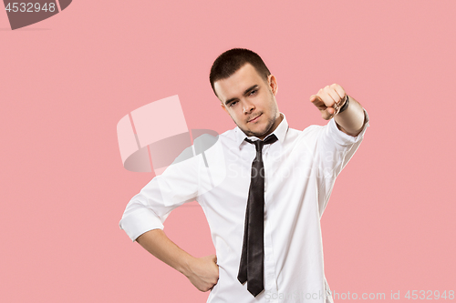 Image of The overbearing businessman point you and want you, half length closeup portrait on pink background.