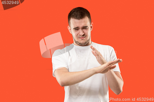 Image of Let me think. Doubtful pensive man with thoughtful expression making choice against orange background