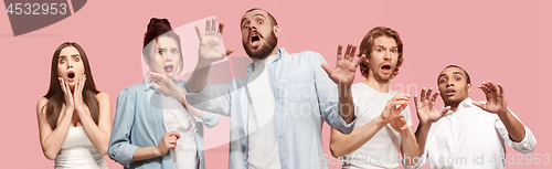 Image of Group of frightened people, woman and man stressful keeping hands on head, terrified in panic, shouting