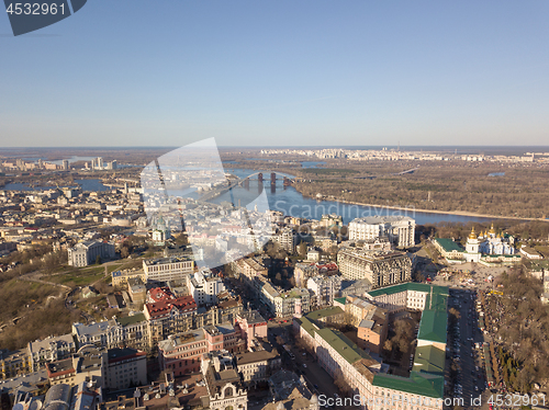 Image of Kiev, Ukraine - April 7, 2018: Landscape view of the old district of Podol with the Vladimir Church and St. Andrew\'s Church against the blue sky