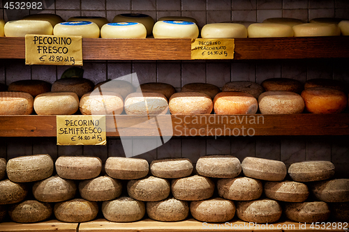 Image of Delicious cheeses in a grocery store in Pienza