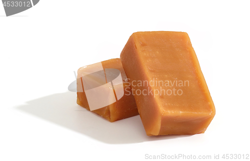 Image of caramel candies on white background